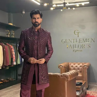 A full view of our three-piece Indo-western set in a rich wine hue. The detailed embroidery on the long jacket creates a stunning visual texture, perfect for a groom's reception look.