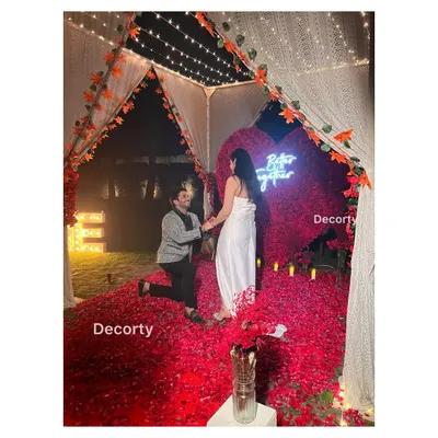 A truly dreamy proposal moment inside a candlelit canopy, set on a bed of red rose petals. I design these intimate and romantic settings to make your 'yes' moment absolutely perfect.