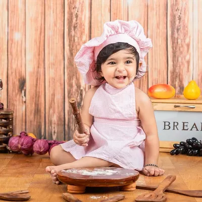 This mini masterchef is ready to bake something sweet! The pink chef hat and apron are just perfect for this little baker girl.