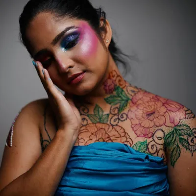 This photo from a creative collaboration shows a large floral henna piece on the chest and shoulder, brought to life with vibrant, skin safe colored henna. It's a perfect example of how henna can be used for editorial and artistic photoshoots.
