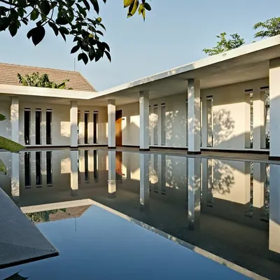 The spa complex at Club Mahindra's Lake Pawana resort is centered around this still expanse of water. The design creates a profound sense of serenity, with the architecture and its reflection merging to form a tranquil, meditative space.