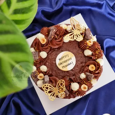 My Triple Chocolate Ganache Brownie Cake is pure indulgence. This 7-inch walnut brownie base is lavishly decorated with different chocolate frostings, hazelnuts, and delicate golden butterflies.
