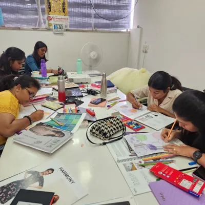 A typical day at the academy, with students fully immersed in a practical session. Here, they are working on color theory and illustration, bringing their design concepts to life on paper.