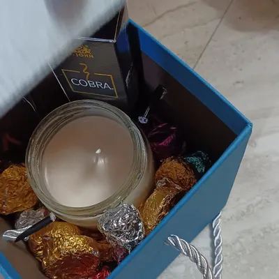 This gift hamper is a great example of a custom order for him, featuring a scented jar candle, a bottle of perfume, and assorted chocolates. I can create a similar hamper for you based on your preferences and budget.