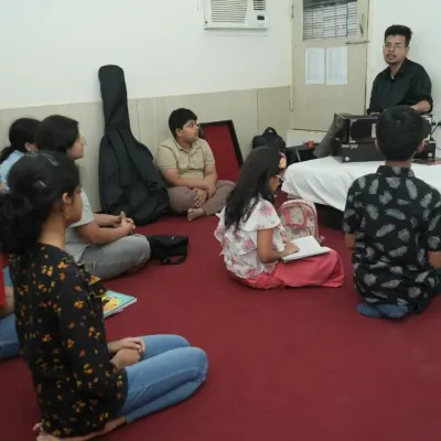 A typical vocal music class in session. Students are seated in a traditional setting, learning from our experienced guru who combines practical singing with essential theory.
