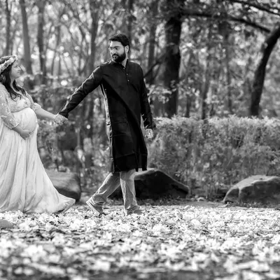 A romantic walk in the park. This beautiful shot captures a quiet moment between the expecting couple. We help you choose the perfect gown to match the mood of your shoot.