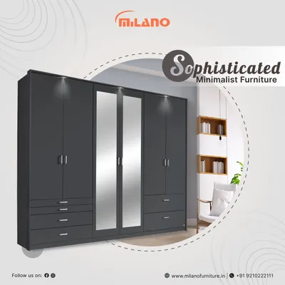 This sophisticated minimalist wardrobe features a dark grey finish, clean lines, and integrated mirrored panels. With ample drawers and hanging space, it's a stylish and practical storage solution for a modern bedroom.
