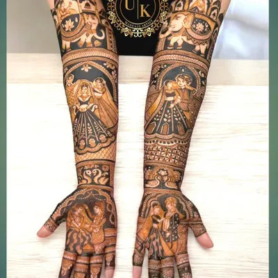 Portrait mehandi is my specialty. This design features incredibly detailed portraits of a couple, along with elephants and other traditional motifs, creating a truly personalized and royal bridal look.