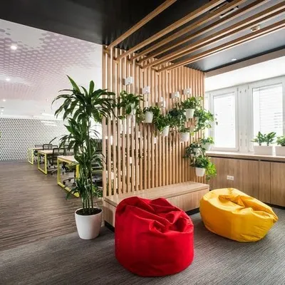 We brought this office breakout area to life with a mix of greenery. The design includes large floor plants, planters by the windows, and a creative hanging garden on a wooden slat wall, making the space more relaxed and inspiring.