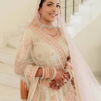 Nidhi looked like a dream for her morning pheras. We chose a soft pink and ivory palette for her makeup to complement her pastel lehenga, focusing on a fresh and luminous skin finish.