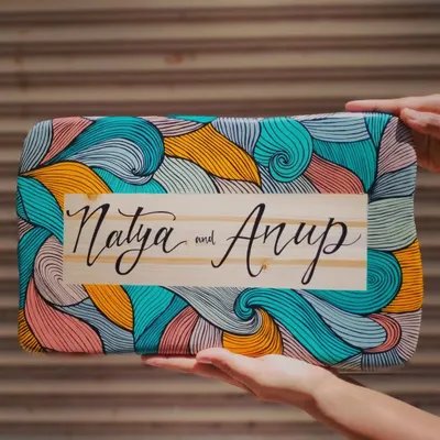 We love how this boho-inspired name plaque for "Natya and Anup" turned out. The natural wood grain in the center contrasts beautifully with the colorful, intricate line art, all painted by hand.