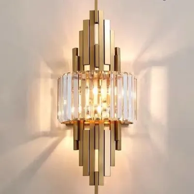 A close-up of my crystal and wrought iron wall lamp. The tiered, geometric design is characteristic of the Art Deco style, with precisely cut crystals that refract light for a dazzling effect.