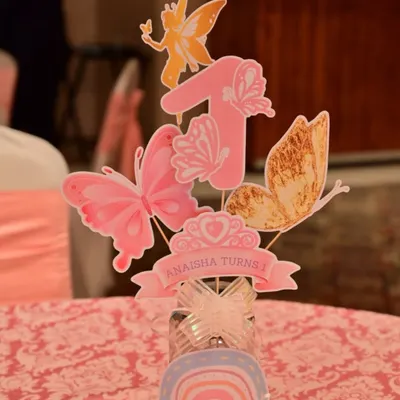 A close-up of a beautiful centerpiece for Anaisha's first birthday. This custom-made piece features the number '1' adorned with delicate paper butterflies, perfectly matching the enchanted garden theme.
