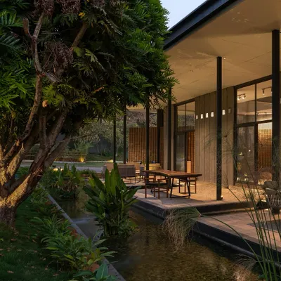 At dusk, 'The Earth' experience center glows with warmth, its lightweight MS frame and dry-clad granite walls settling into the landscape. The design is a beacon of sustainable architecture, blending modern techniques with timeless materials.