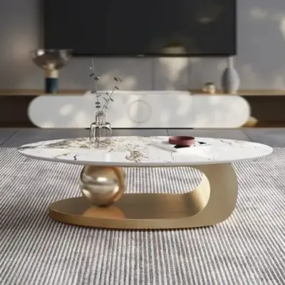 This is one of my signature center table designs, featuring a marble top that appears to be balanced on a sculptural golden base. It's a true conversation starter.