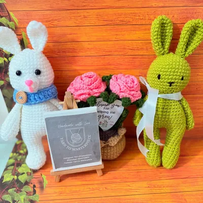 A friendly group of my handmade creations, featuring two crochet bunnies and a potted rose arrangement. This shows how my different pieces can be mixed and matched for a beautiful gift set.