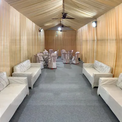 A simple and functional setup for an indoor office event. I used neutral-colored drapes to create a temporary enclosed space, furnished with sofas and tables for a comfortable lounge area.