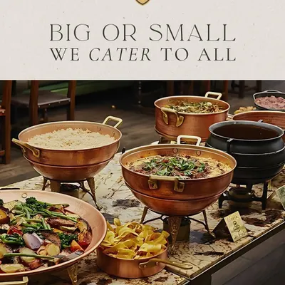 Big or small, I cater to all. This image shows a beautiful buffet line with a variety of main courses served in traditional copper and brass chafing dishes, suitable for any size of corporate gathering.