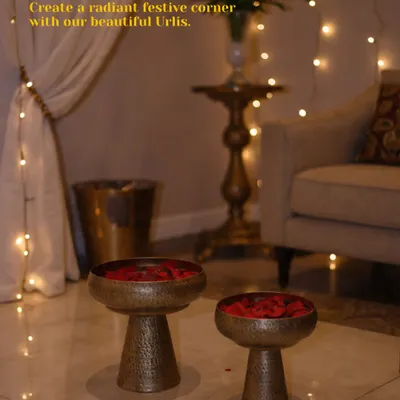 Create a radiant festive corner with my hammered metal urlis. Here, they are filled with rose petals and placed at an entrance, instantly setting a welcoming and celebratory mood.