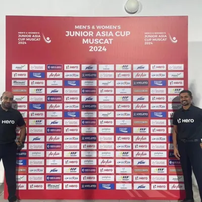 A proud moment for our club as our senior player and national umpire, Suraj Dubey, stands before the official backdrop at the Men's Junior Asia Cup in Muscat. This is his first international tour, a testament to his expertise and our club's commitment to developing top-tier officials.