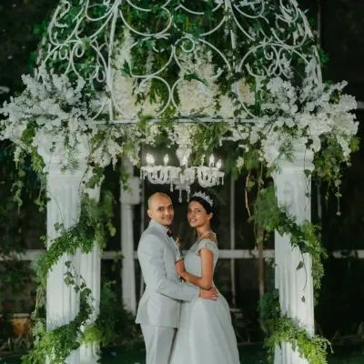 A fairytale moment captured under a beautiful white gazebo adorned with flowers and greenery. I create these classic, romantic settings for your perfect "I do".