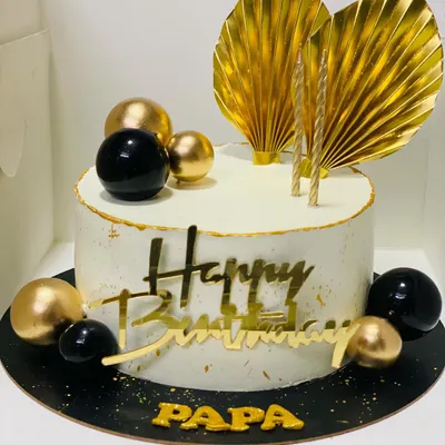 A classy black and gold themed cake for a father's birthday, exuding luxury and style.