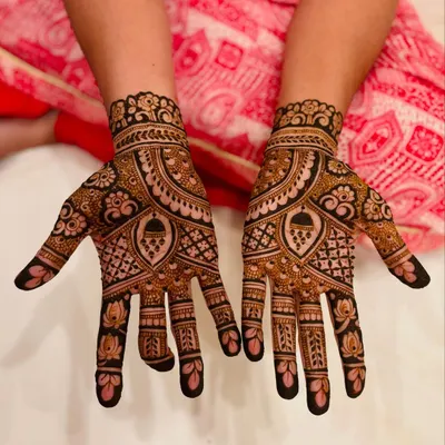 A rich and detailed mehendi design for the bride's mom, filled with traditional motifs to make her feel just as special.