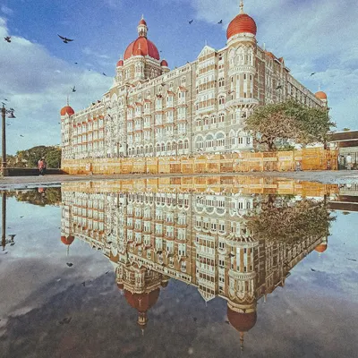 A classic reflection of the Taj Mahal Palace hotel in a monsoon puddle. This shot captures the grandeur of Mumbai's heritage architecture, a recurring theme in my work.
