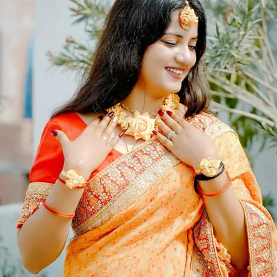 A beautiful candid shot of a bride during her Haldi ceremony, adorned with floral jewelry. We capture the natural glow and happiness of this sun-kissed ritual.