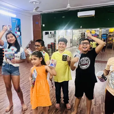 A happy group of kids celebrating with their prizes after a workshop. This is what our community is all about: learning, having fun, and cheering each other on.