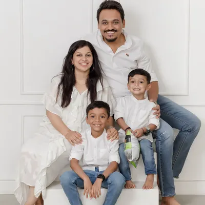 A beautiful family of four dressed in classic white and denim. This timeless style allows the family's connection and joy to be the true focus of the portrait.