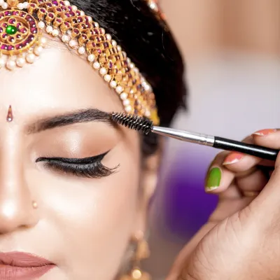A close-up shot of the bride's eye makeup, capturing the artistry of the makeup artist and the final touches before the ceremony.