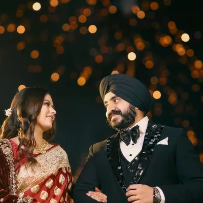 A classic, romantic portrait of a couple on their reception night, framed against a beautiful bokeh of distant lights. This shot is all about capturing the magic and intimacy of the evening.