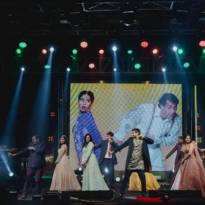 We love adding a touch of humor and nostalgia. This performance recreated a classic comedy scene from a Bollywood movie, complete with a matching background visual, which had the audience in splits.