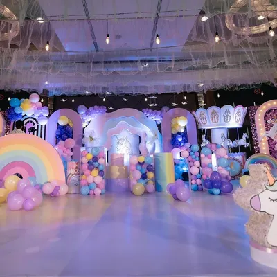 A full view of our unicorn theme setup, featuring multiple custom arches, a carousel, and a floor-to-ceiling balloon installation. We design every element to create a complete, immersive party experience.