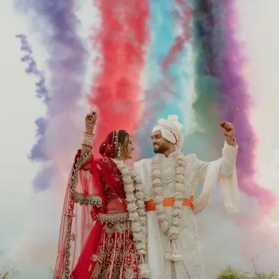 A truly epic varmala moment. I framed the couple against a backdrop of colorful smoke, creating a vibrant and unforgettable image that perfectly captures the joy and energy of their union.