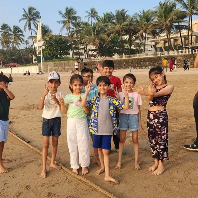 Peace and smiles! A group of happy kids posing for a photo during our super fun beach playdate.