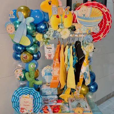 Our signature 'It's a Boy' baby wardrobe trousseau, fully assembled and ready to gift. It features a mini clothing rack with assorted outfits, a balloon arch, soft toys, and personalized cutouts, making it a stunning centerpiece for any baby shower or welcome party.