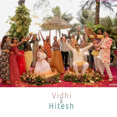 The perfect Haldi group shot. A moment of celebration as friends and family shower the couple with flower petals, capturing the peak of the fun and energy.