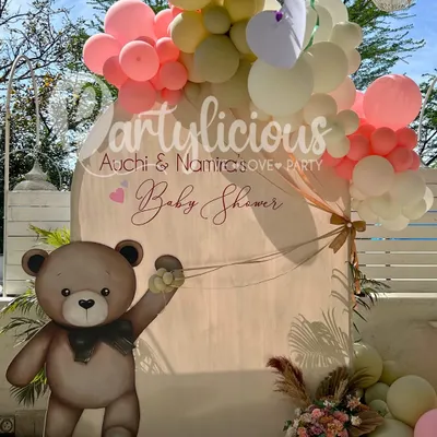 A 'beary' special day for a baby shower. This setup features our popular teddy bear prop against a custom arched backdrop, surrounded by a soft and dreamy pastel balloon garland. It's the perfect sweet and gentle theme to celebrate a new arrival.