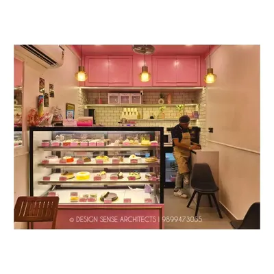 A look inside the Pink Box bakery. We used a consistent pink color palette for the cabinets and display counter, complemented by white subway tiles and warm pendant lights to create a sweet and inviting interior.