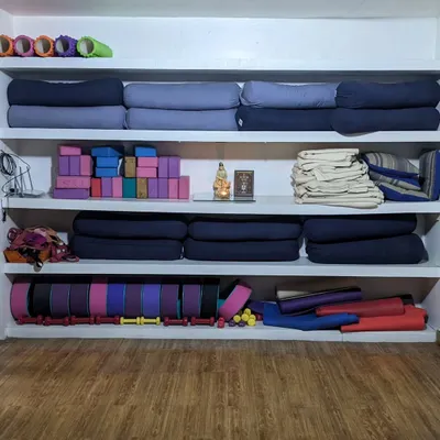 Welcome to our wall of props. Each item here, from bolsters and blocks to belts and rollers, is a tool to help you find support, deepen your stretch, and practice safely in our studio.