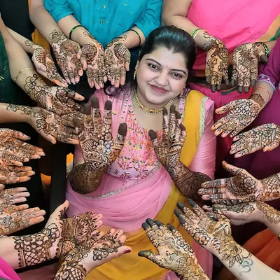A classic mehendi party photo. I love capturing this moment with the bride surrounded by her friends and family, all showing off their beautiful henna designs.