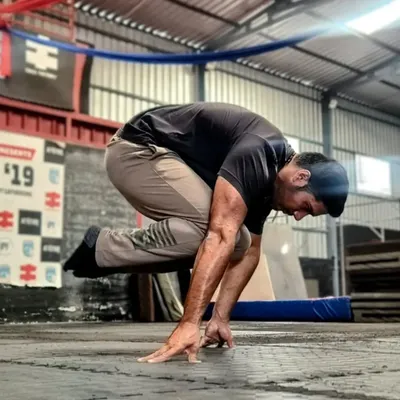 A clear shot of the tuck planche. This is where the journey begins. Mastering this position builds the foundational strength and wrist conditioning needed for all planche variations.