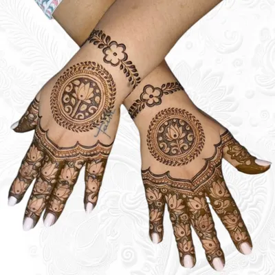 A beautiful and balanced backhand design featuring a lotus mandala in the center with a simple floral bracelet.