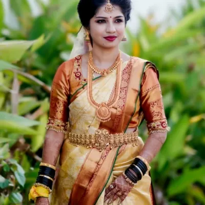 A classic South Indian bridal portrait. This look features a beautiful Kanjeevaram saree, traditional gold temple jewellery, and a bold red lip for a timeless finish.