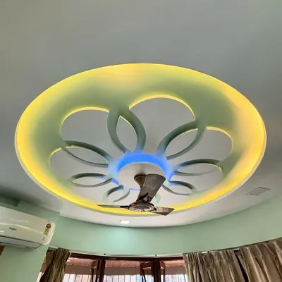 A side view of the completed floral-patterned false ceiling. The design adds depth and character, integrating the ceiling fan seamlessly while providing beautiful, layered lighting.