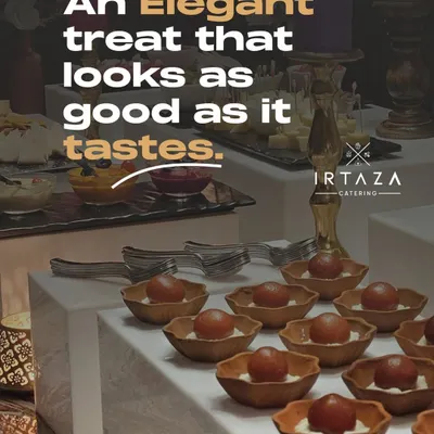 An elegant dessert spread featuring Gulab Jamun with a creamy base, served in beautiful individual bowls. It's a treat that looks as good as it tastes.