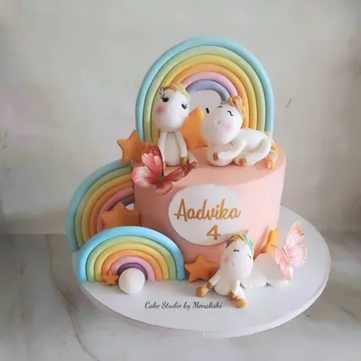 This absolutely stunning unicorn themed cake was handcrafted with love for a 4th birthday. It features multiple rainbows and adorable unicorn figures, all made from fondant to create a magical scene.