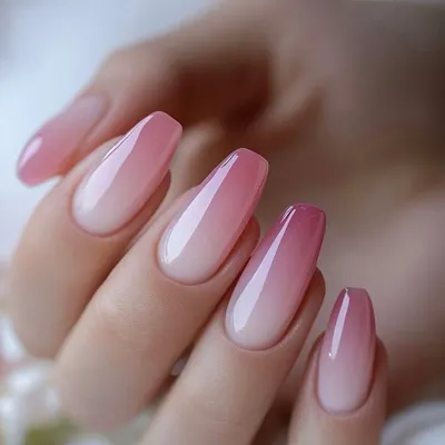 A perfect example of a pink and white ombre, or "baby boomer" nail. The seamless blend of color on this elegant coffin shape is a classic and popular choice.